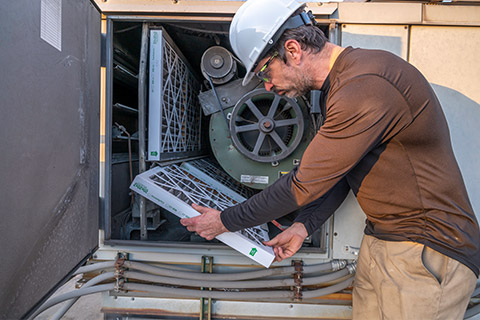 man performing Air Handler Unit Restoration in Manassas, VA, Tysons, VA, Washington, DC, and Nearby Cities